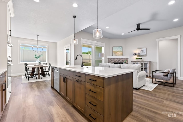 1501 E Andes Dr, Kuna, ID 83634 - kitchen featuring dishwasher, wood finished floors, light countertops, recessed lighting, and ceiling fan