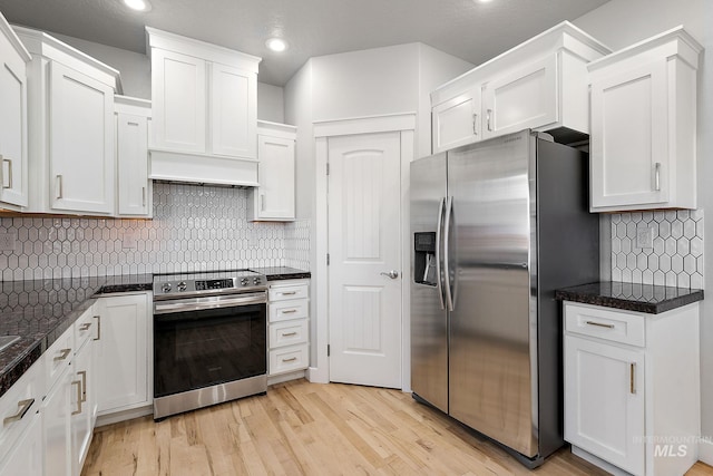 kitchen with recessed lighting, stainless steel appliances, white cabinets, light wood-type flooring, and backsplash