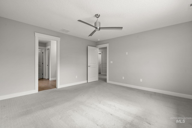 unfurnished bedroom featuring carpet flooring, ceiling fan, a textured ceiling, and baseboards