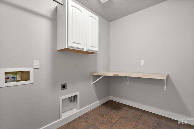 laundry room featuring baseboards, washer hookup, cabinet space, hookup for an electric dryer, and a textured ceiling