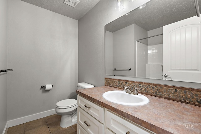 full bath featuring vanity, visible vents, a textured ceiling, tile patterned floors, and toilet