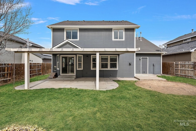 back of property with a patio area, a yard, a fenced backyard, and entry steps