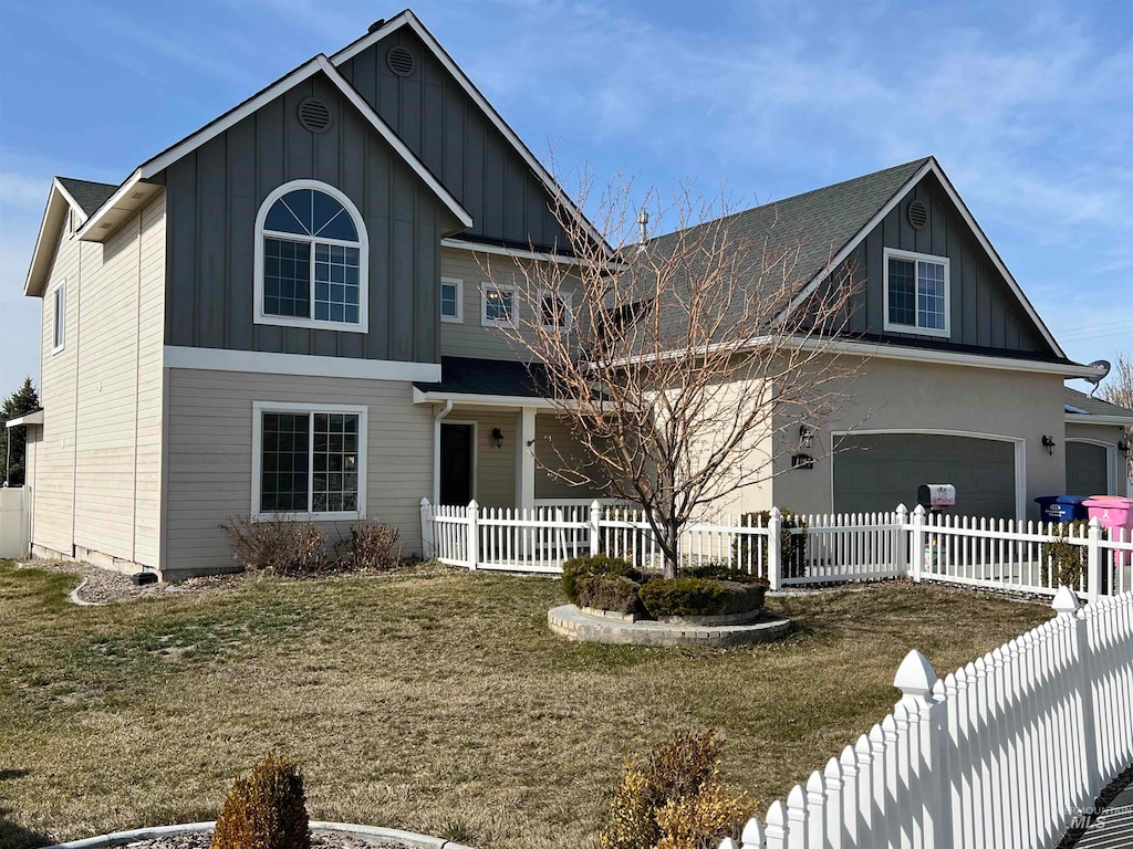 view of front facade with a front yard and a garage