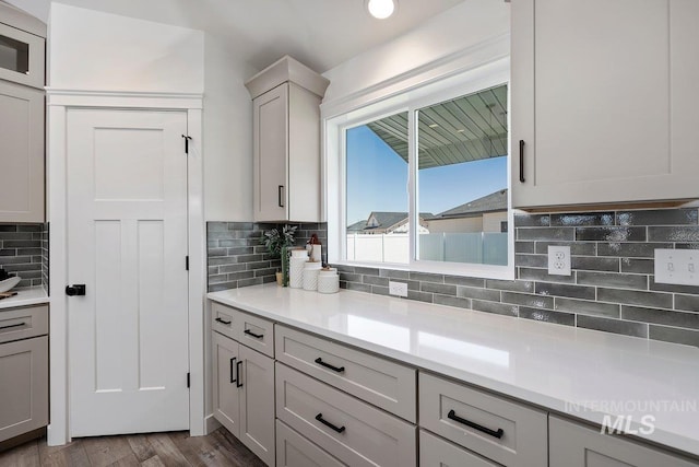 958 Gregory Way, Twin Falls, ID 83301 - kitchen featuring decorative backsplash, light countertops, wood finished floors, and gray cabinets