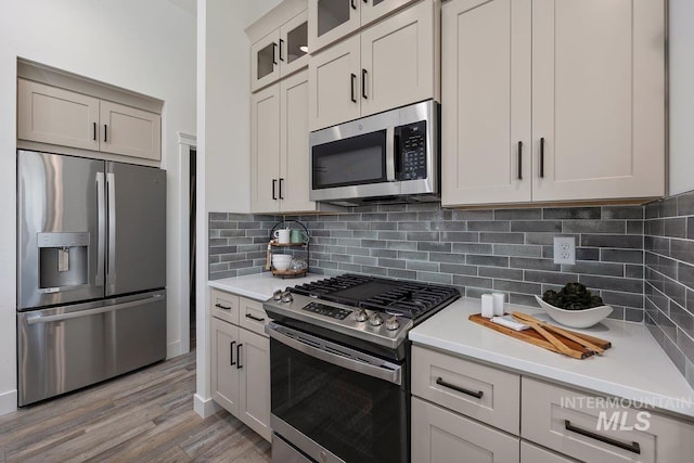 958 Gregory Way, Twin Falls, ID 83301 - kitchen featuring appliances with stainless steel finishes, light countertops, and glass insert cabinets