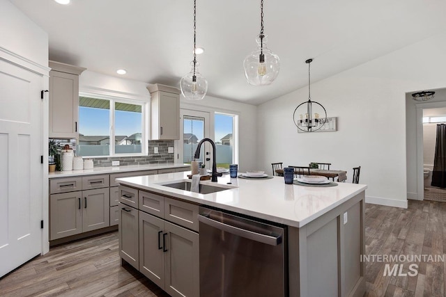 958 Gregory Way, Twin Falls, ID 83301 - kitchen featuring stainless steel dishwasher, a sink, gray cabinets, light countertops, and tasteful backsplash