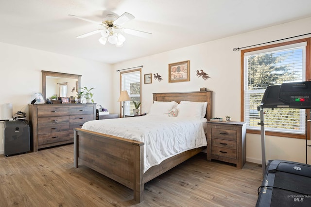 bedroom with ceiling fan and hardwood / wood-style floors