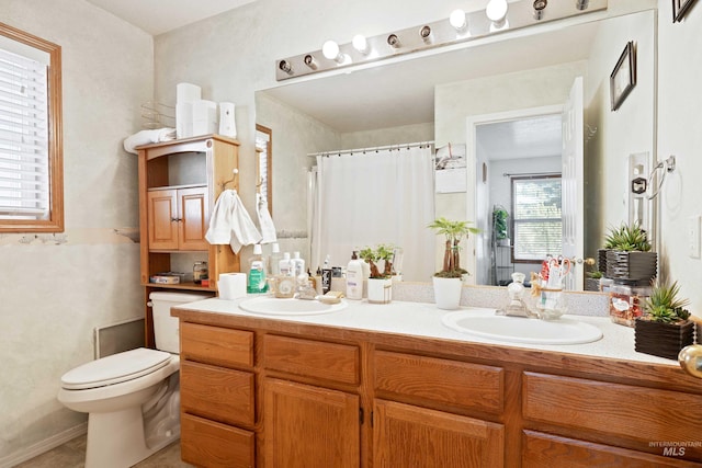 bathroom with a shower with shower curtain, vanity, and toilet