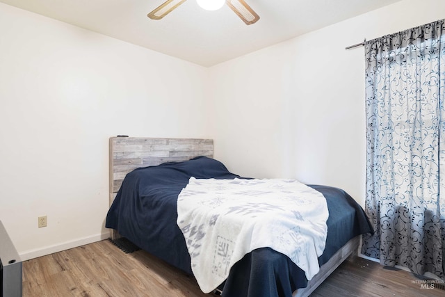 bedroom with ceiling fan and hardwood / wood-style flooring