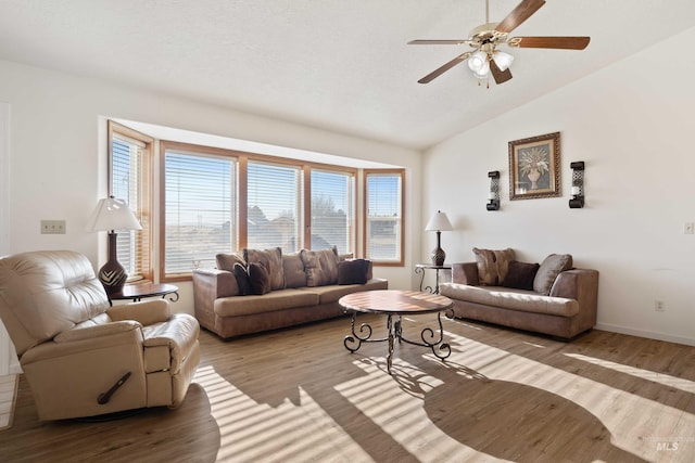 living room with light hardwood / wood-style floors, ceiling fan, and lofted ceiling