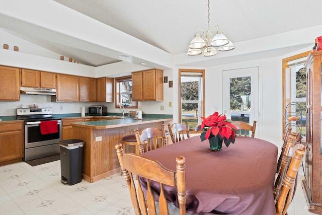 dining space featuring lofted ceiling, an inviting chandelier, and sink