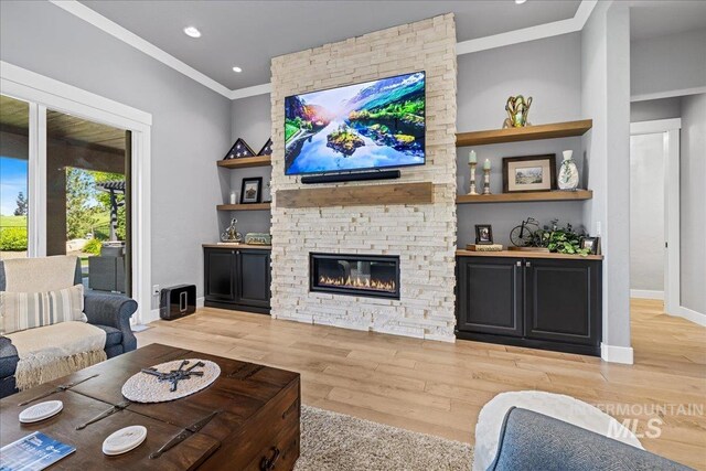 1427 N Morehouse, Eagle, ID 83616 - living area with crown molding, wood finished floors, a stone fireplace, baseboards, and recessed lighting