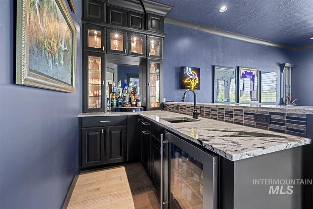 1427 N Morehouse, Eagle, ID 83616 - indoor wet bar featuring wine cooler, light wood-style floors, recessed lighting, and a textured ceiling