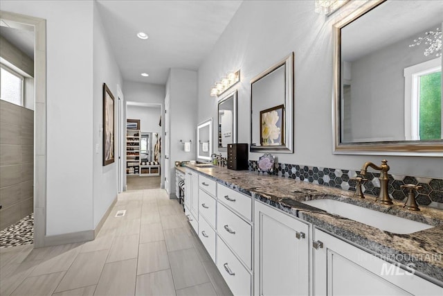 1427 N Morehouse, Eagle, ID 83616 - bathroom featuring double vanity, recessed lighting, a walk in closet, and baseboards