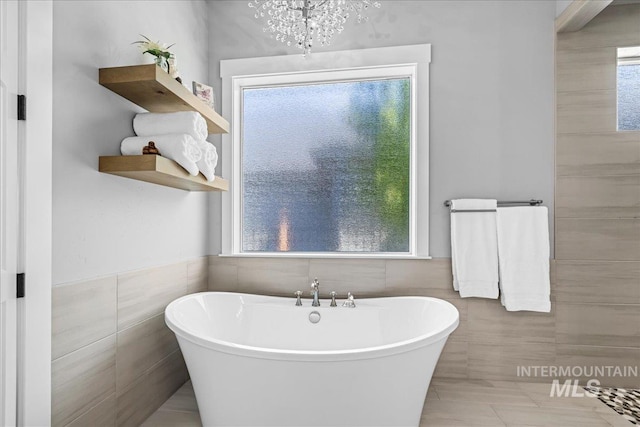 1427 N Morehouse, Eagle, ID 83616 - bathroom with tile walls, a freestanding bath, a chandelier, and wainscoting