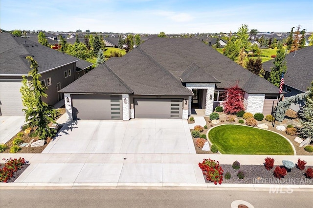 1427 N Morehouse, Eagle, ID 83616 - view of front of home with an attached garage, driveway, a residential view, stone siding, and a front yard