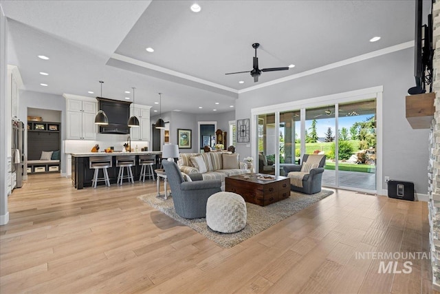 1427 N Morehouse, Eagle, ID 83616 - living room featuring a ceiling fan, light wood-style flooring, recessed lighting, crown molding, and baseboards