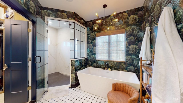 full bath featuring wallpapered walls, a freestanding bath, and a shower stall