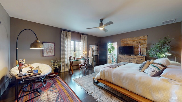 bedroom featuring visible vents, ceiling fan, and wood finished floors
