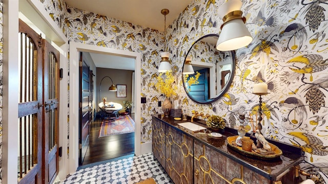 bathroom featuring wallpapered walls and vanity
