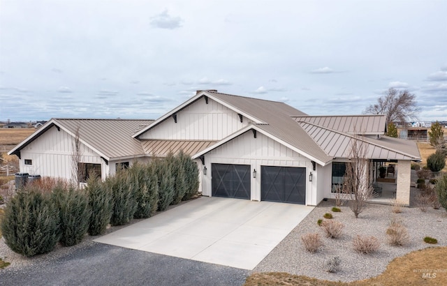 modern farmhouse style home with metal roof, a garage, a standing seam roof, board and batten siding, and driveway