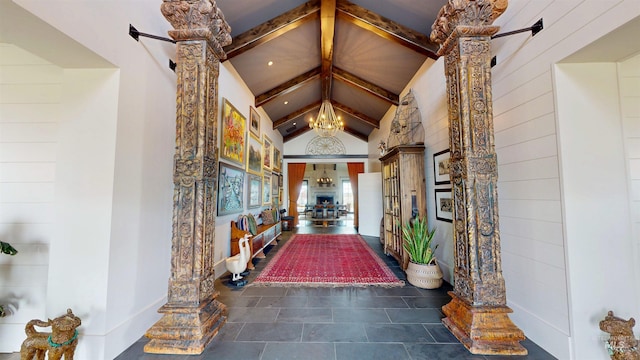 corridor featuring lofted ceiling with beams and a chandelier