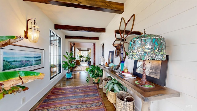 hall featuring wood finished floors and beam ceiling