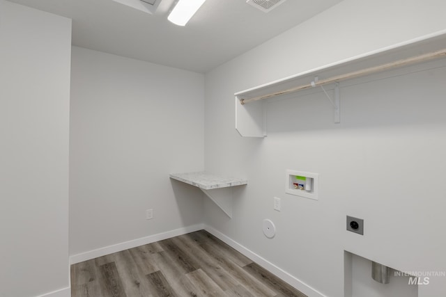 laundry room with wood finished floors, laundry area, hookup for an electric dryer, baseboards, and hookup for a washing machine