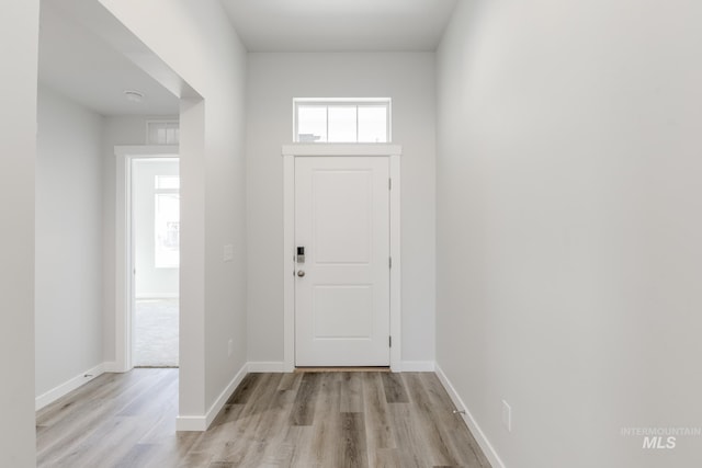 entryway featuring baseboards and light wood-style floors