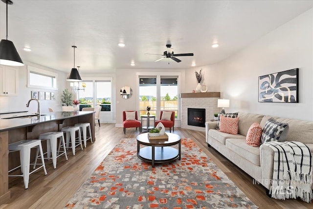 499 S Short Ln, Eagle, ID 83616 - living area with light wood-style flooring, a fireplace, ceiling fan, and recessed lighting