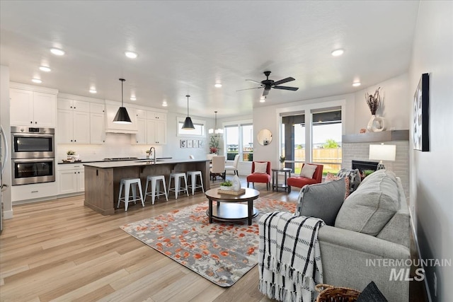 499 S Short Ln, Eagle, ID 83616 - living area featuring recessed lighting, light wood-style flooring, a ceiling fan, and a brick fireplace