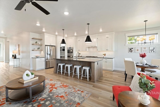 499 S Short Ln, Eagle, ID 83616 - living room with a chandelier, light wood-style floors, a ceiling fan, and recessed lighting