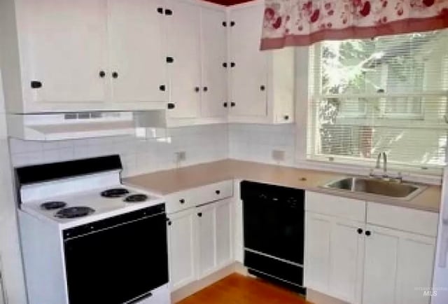 kitchen with white cabinets, black dishwasher, ventilation hood, and electric stove