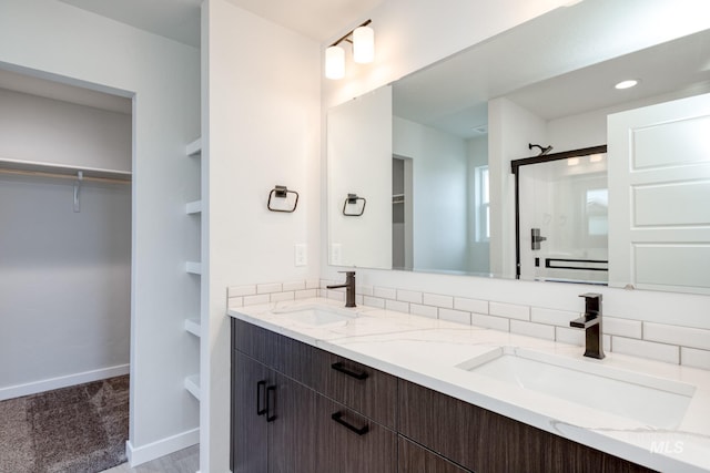 bathroom with vanity and a shower with door