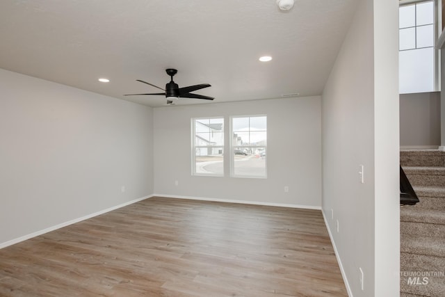 spare room featuring light hardwood / wood-style flooring and ceiling fan