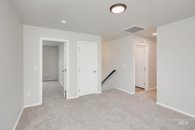 spare room with light colored carpet