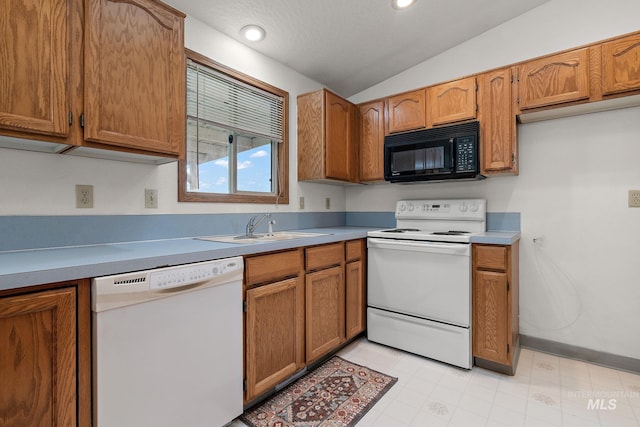 607 S State, Nampa, ID 83686 - kitchen with white appliances, a sink, brown cabinets, vaulted ceiling, and light countertops