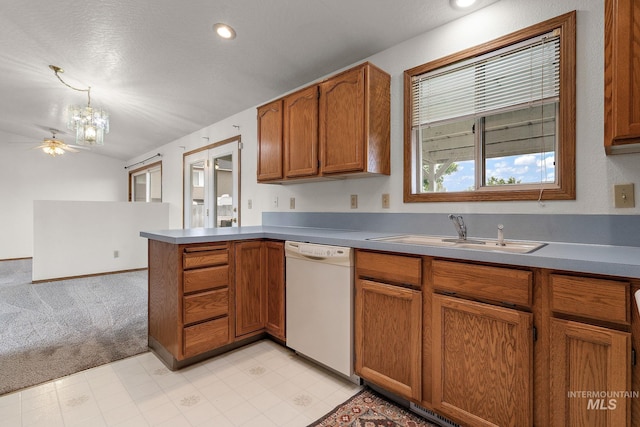 607 S State, Nampa, ID 83686 - kitchen featuring white dishwasher, a sink, a peninsula, brown cabinets, and light carpet