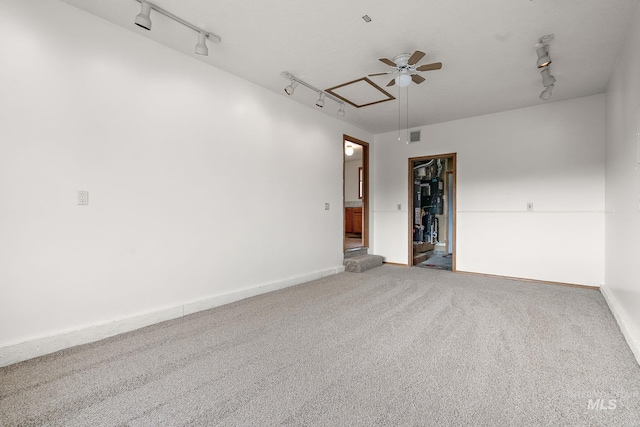 607 S State, Nampa, ID 83686 - spare room with track lighting, attic access, ceiling fan, and carpet flooring