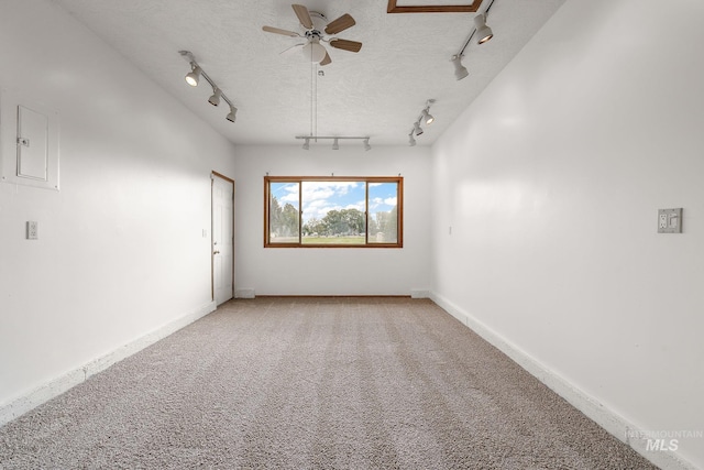 607 S State, Nampa, ID 83686 - empty room with track lighting, a ceiling fan, and light colored carpet