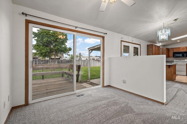 607 S State, Nampa, ID 83686 - unfurnished living room featuring light carpet, baseboards, a chandelier, and ceiling fan