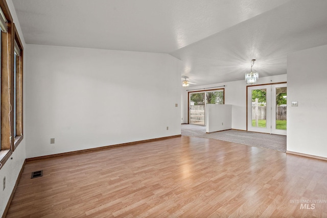 607 S State, Nampa, ID 83686 - empty room with wood finished floors, a chandelier, a ceiling fan, and baseboards