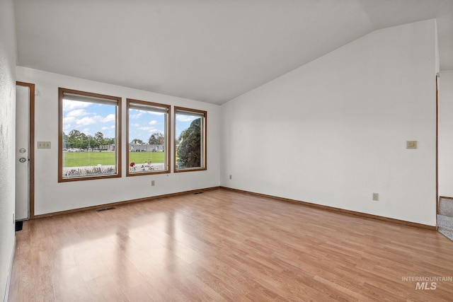 607 S State, Nampa, ID 83686 - spare room featuring vaulted ceiling, light wood-type flooring, and baseboards