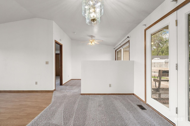 607 S State, Nampa, ID 83686 - unfurnished room with a ceiling fan, vaulted ceiling, a chandelier, carpet flooring, and baseboards