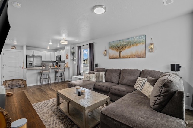 living room with dark hardwood / wood-style floors