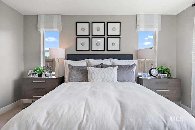 bedroom with carpet flooring and multiple windows