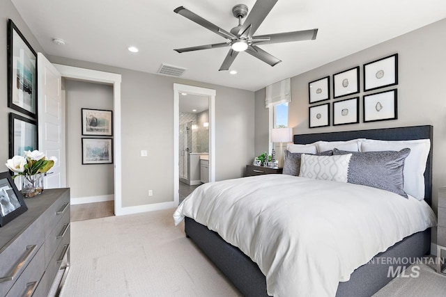 bedroom with ceiling fan, light wood-type flooring, and connected bathroom