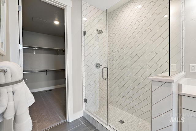 bathroom with walk in shower and tile patterned floors