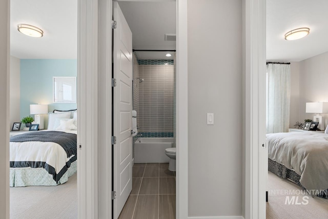 interior space featuring tile patterned floors and ensuite bathroom