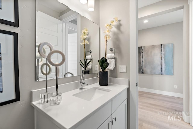 bathroom with vanity and hardwood / wood-style floors